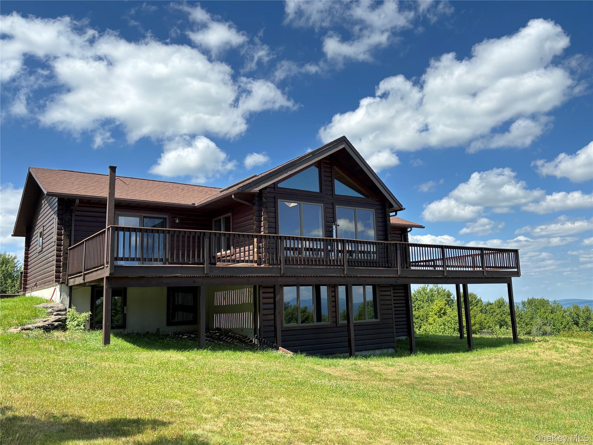 a view of a house with a yard and sitting area