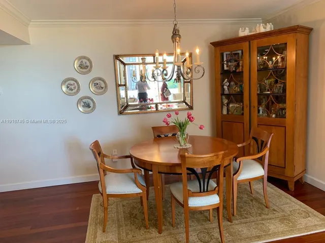 a view of a dining room with furniture and chandelier