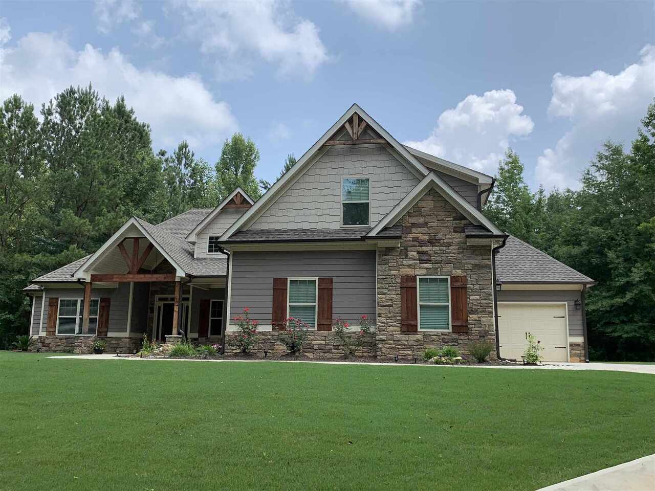 1845 Rocky Creek Road Hampton, GA 30228 - Photo 1 of 1 a front view of a house with a garden and porch