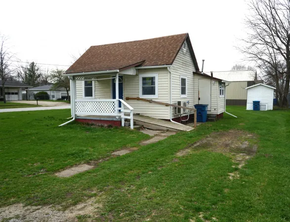 a front view of house with a garden and patio
