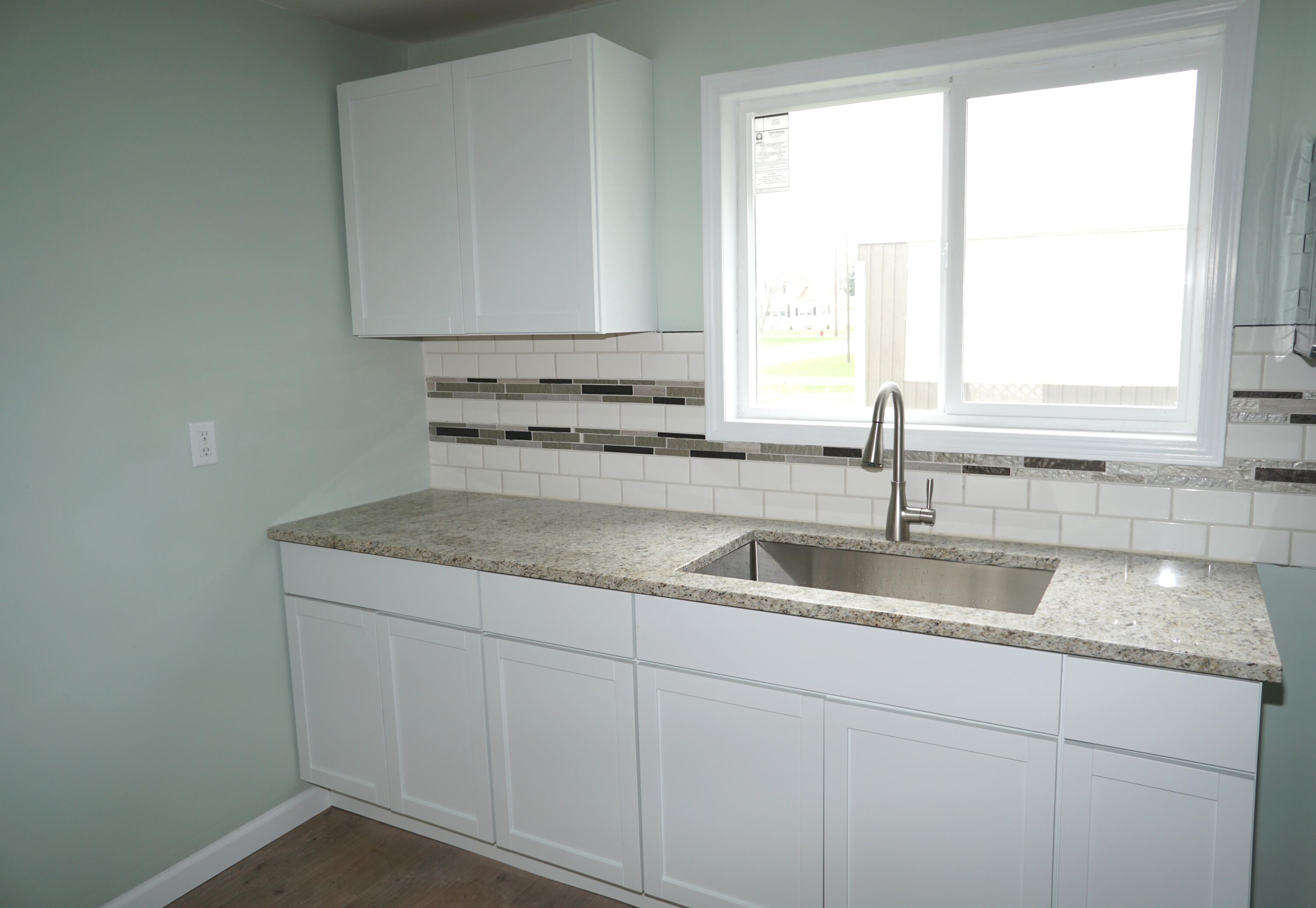 307 South East Street Knox, IN 46534 - Photo 7 of 15 a kitchen with a sink cabinets and window