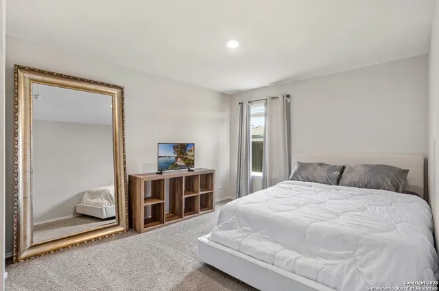 a bedroom with a bed and a view of bedroom