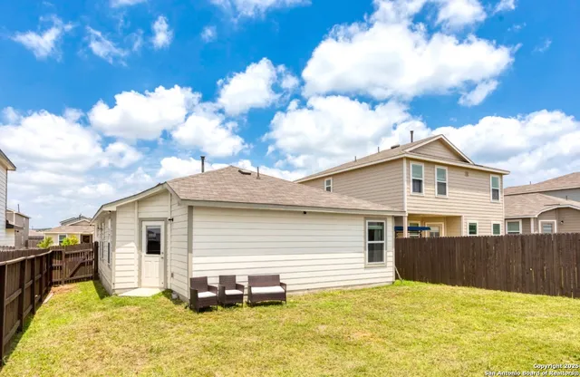a view of a house with a backyard