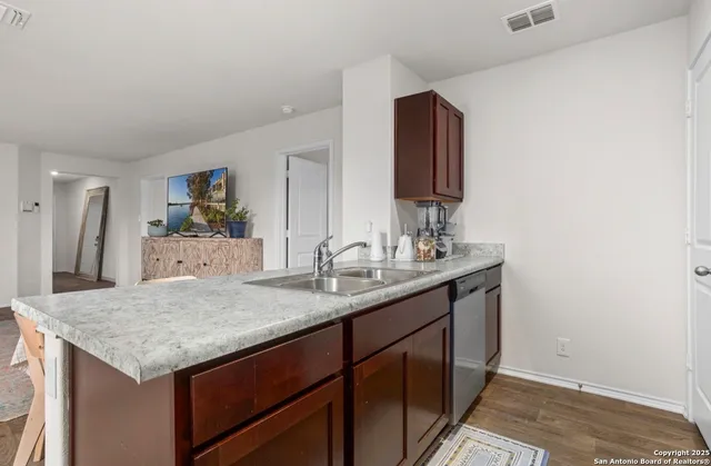 a bathroom with a granite countertop sink and a mirror
