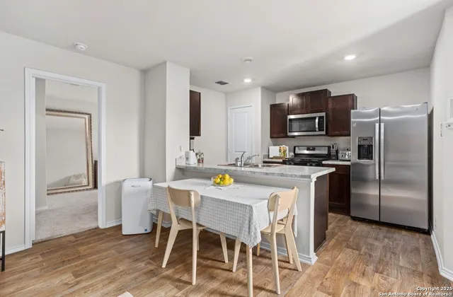 a kitchen with stainless steel appliances a refrigerator stove microwave and cabinets