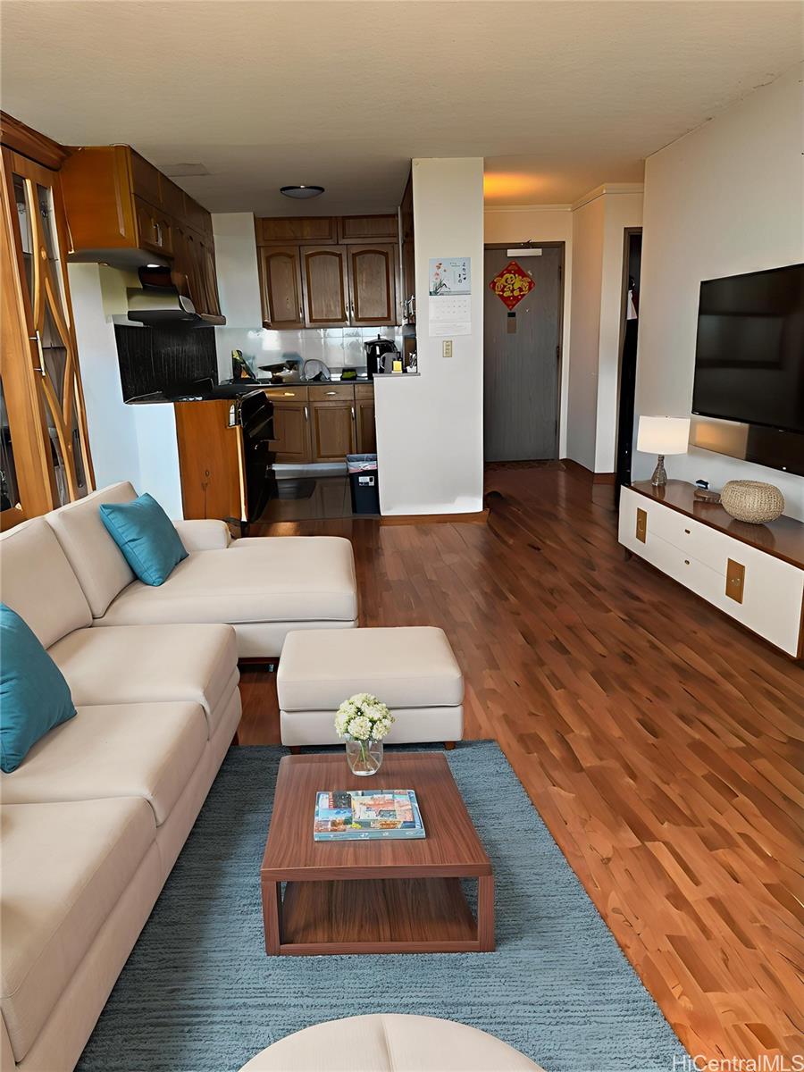 3161 Ala Ilima Street, Unit 1907 Honolulu, HI 96818 - Photo 4 of 12 a living room with furniture and a flat screen tv