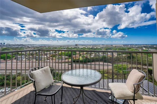 a balcony with table and chairs