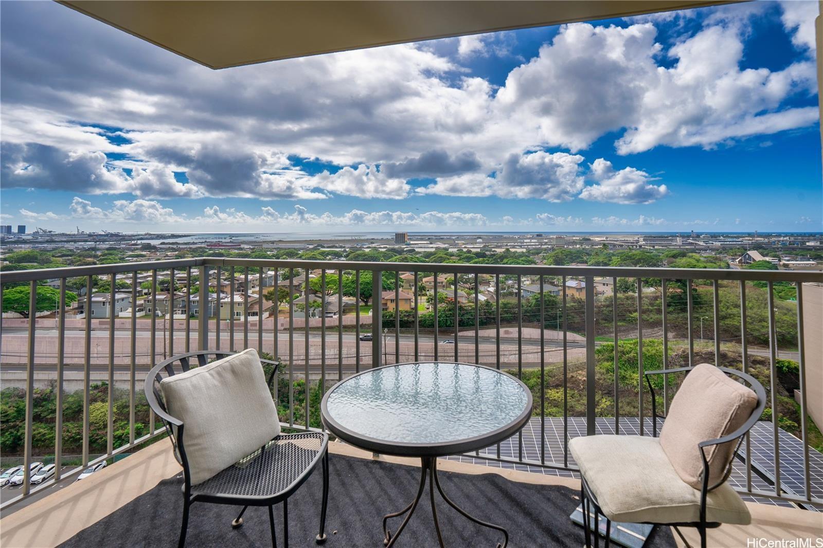 3161 Ala Ilima Street, Unit 1907 Honolulu, HI 96818 - Photo 7 of 12 a balcony with table and chairs