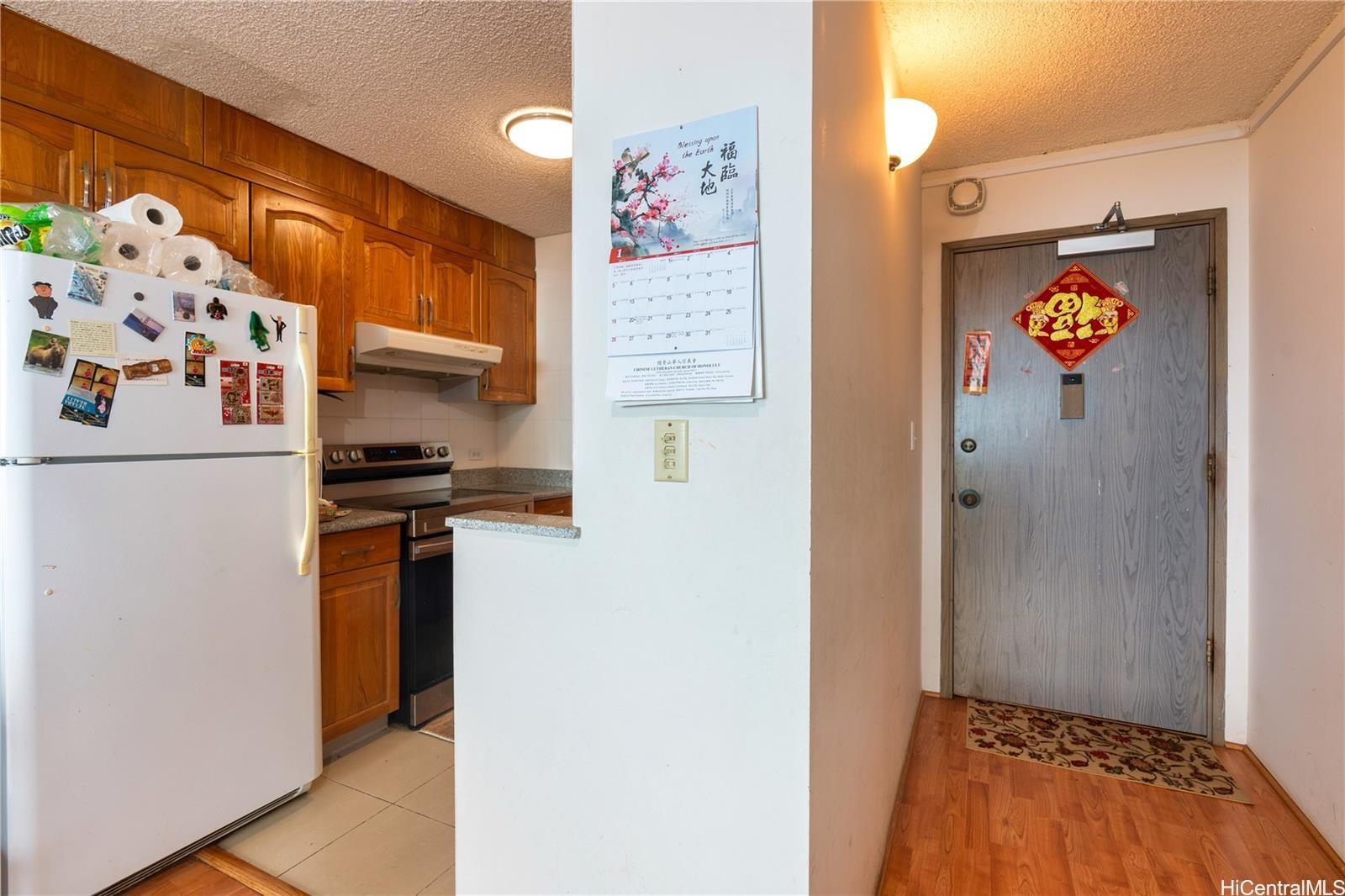 3161 Ala Ilima Street, Unit 1907 Honolulu, HI 96818 - Photo 9 of 12 a view of kitchen with a refrigerator and a stove