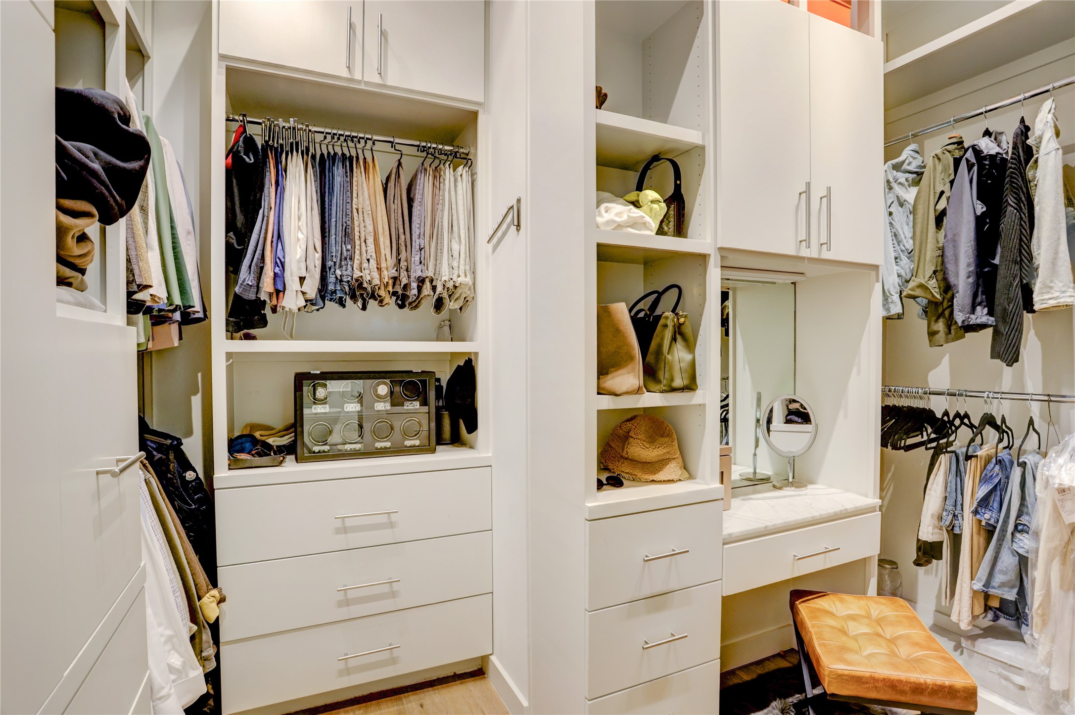 1807 Indiana Street Houston, TX 77006 - Photo 26 of 35 Primary Walk-In Closet: Custom boutique-style primary closet featuring floor-to-ceiling built-in storage, soft-close drawers, dedicated handbag shelving, and an integrated marble-topped vanity station.