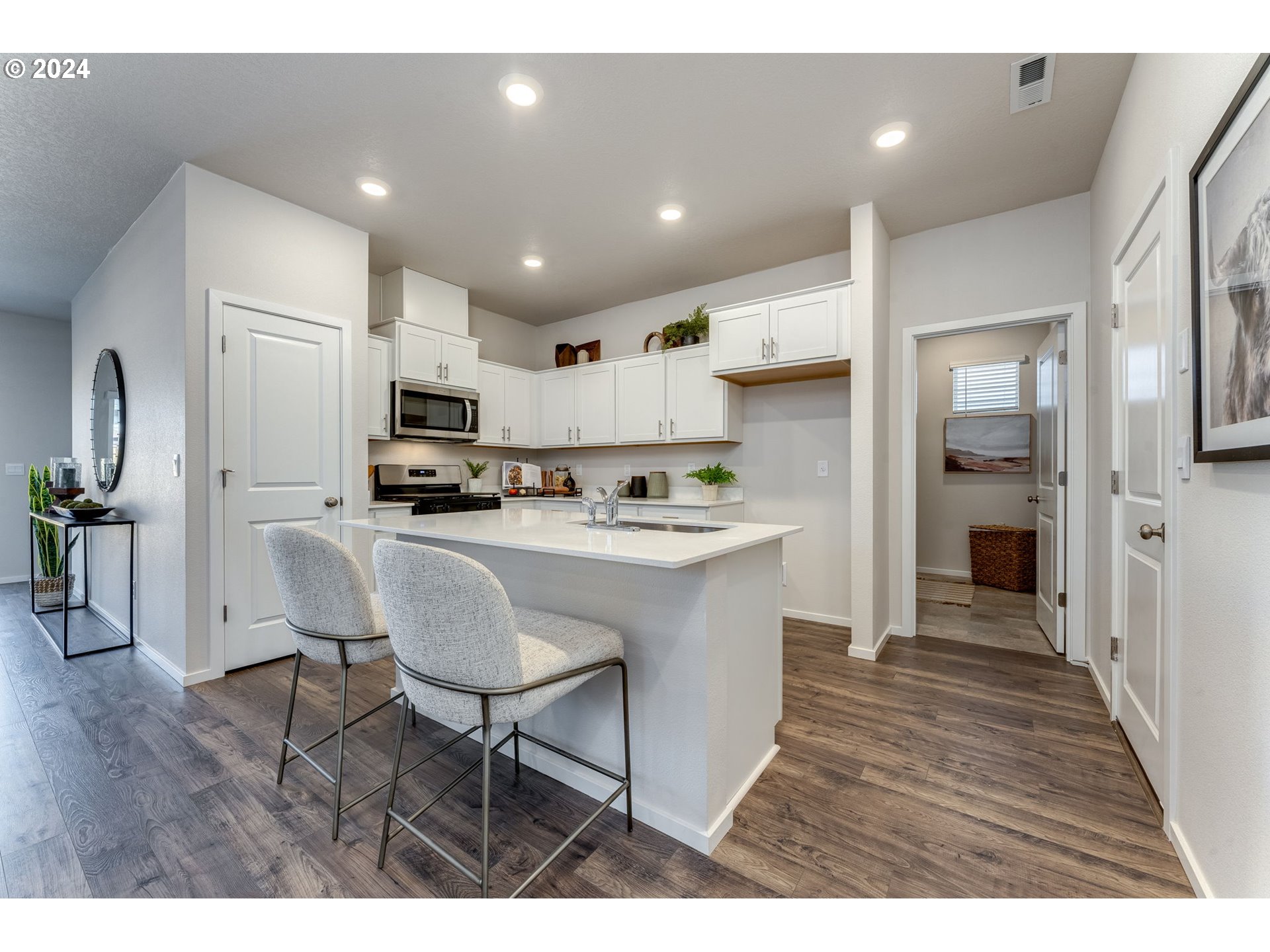 2760 U Street Springfield, OR 97477 - Photo 18 of 48 a kitchen with stainless steel appliances kitchen island granite countertop a refrigerator and a stove top oven