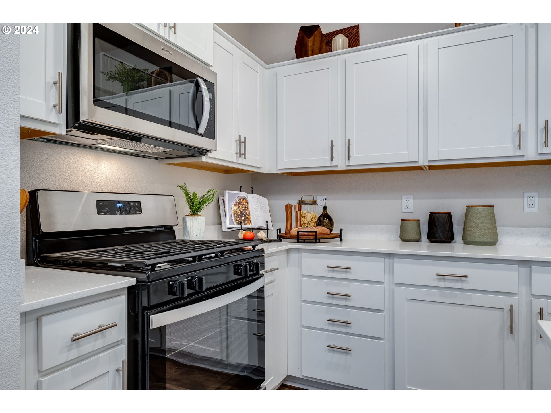 2760 U Street Springfield, OR 97477 - Photo 26 of 48 a kitchen with stainless steel appliances granite countertop white cabinets and a stove a oven with white countertops