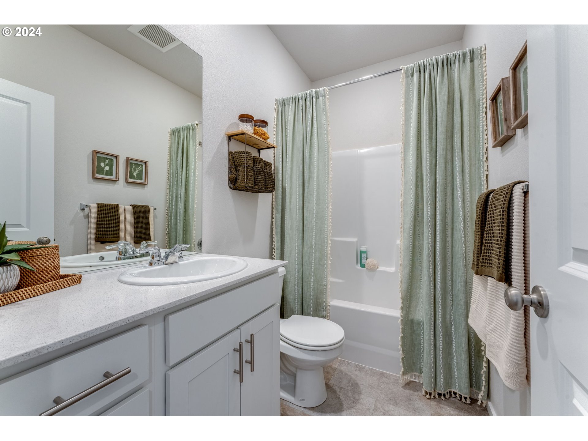 2760 U Street Springfield, OR 97477 - Photo 6 of 48 a bathroom with a granite countertop sink toilet a mirror a vanity and shower