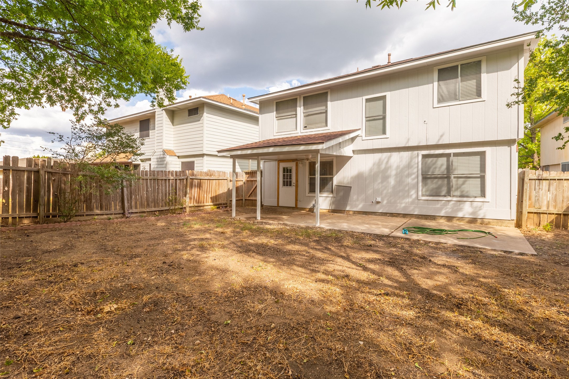 8506 Bisbee Court Austin, TX 78745 - Photo 17 of 20 Expansive backyard with a covered patio and concrete slab
