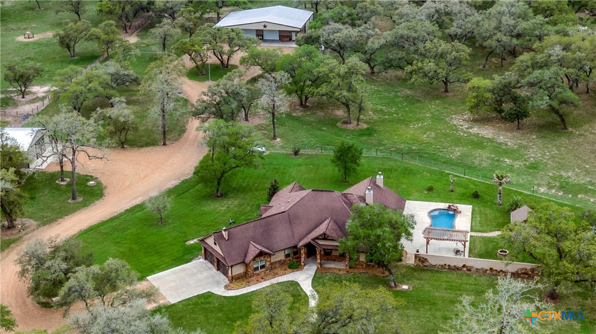 an aerial view of a house with garden space and street view