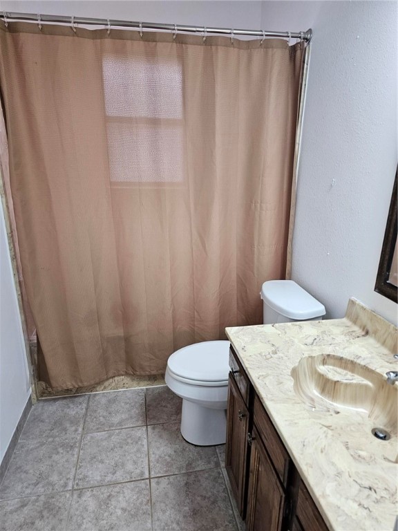 4813 Shadowbend Drive Corpus Christi, TX 78413 - Photo 11 of 12 a bathroom with a granite countertop sink and a toilet