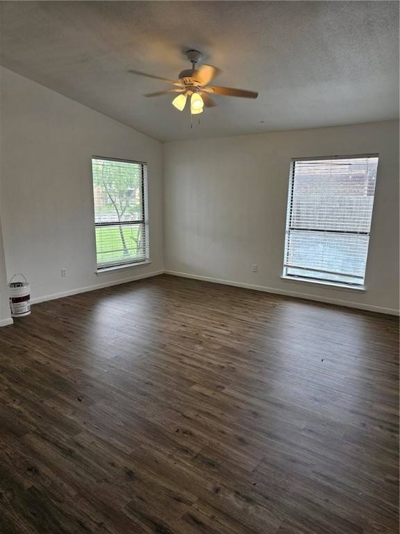 4813 Shadowbend Drive Corpus Christi, TX 78413 - Photo 3 of 12 an empty room with wooden floor chandelier fan and windows