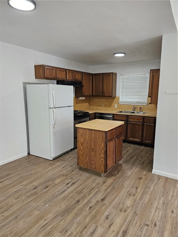 4813 Shadowbend Drive Corpus Christi, TX 78413 - Photo 5 of 12 a kitchen with stainless steel appliances wooden floors and wooden cabinets