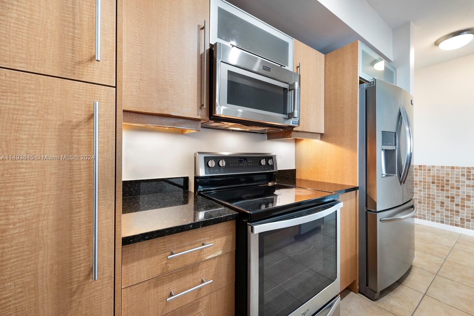 7355 Southwest 89th Street, Unit 510N Miami, FL 33156 - Photo 12 of 52 a kitchen with a refrigerator and microwave