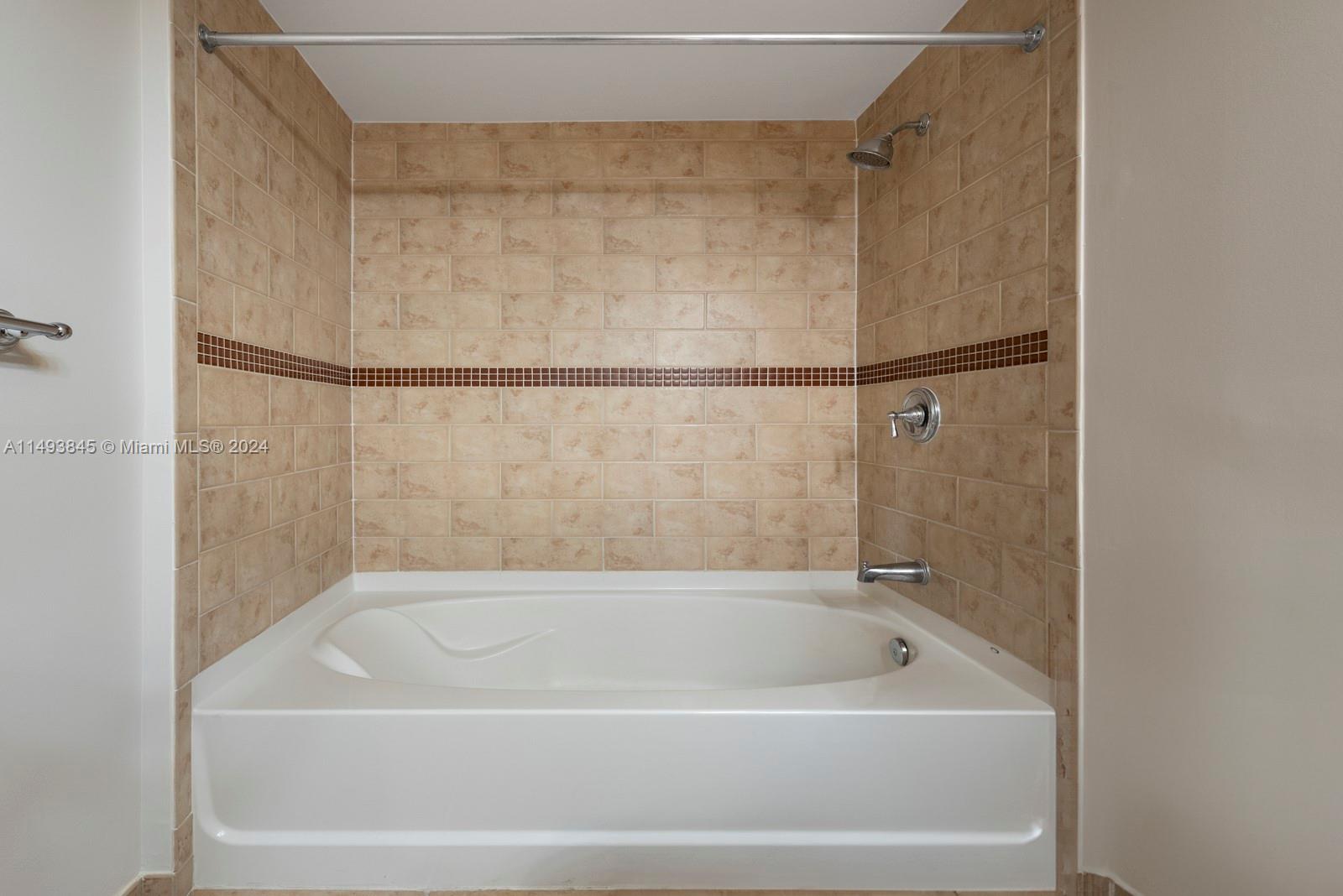 7355 Southwest 89th Street, Unit 510N Miami, FL 33156 - Photo 16 of 52 a bathroom with a bathtub
