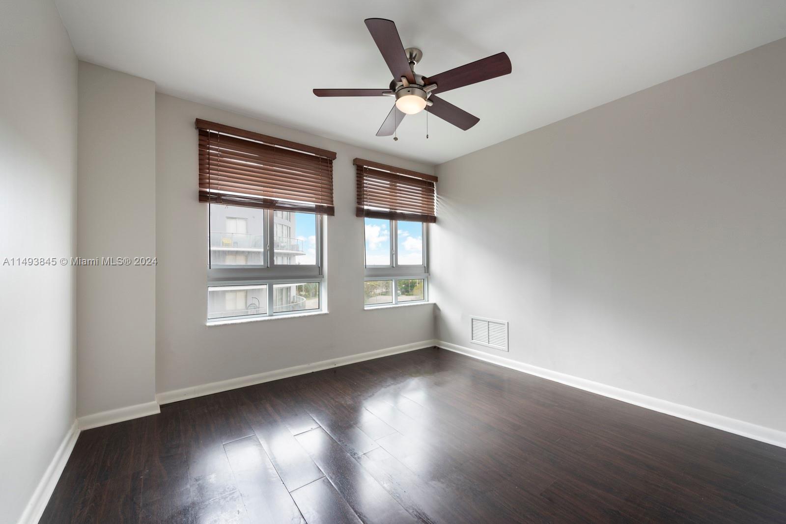 7355 Southwest 89th Street, Unit 510N Miami, FL 33156 - Photo 21 of 52 a view of an empty room with wooden floor and a window