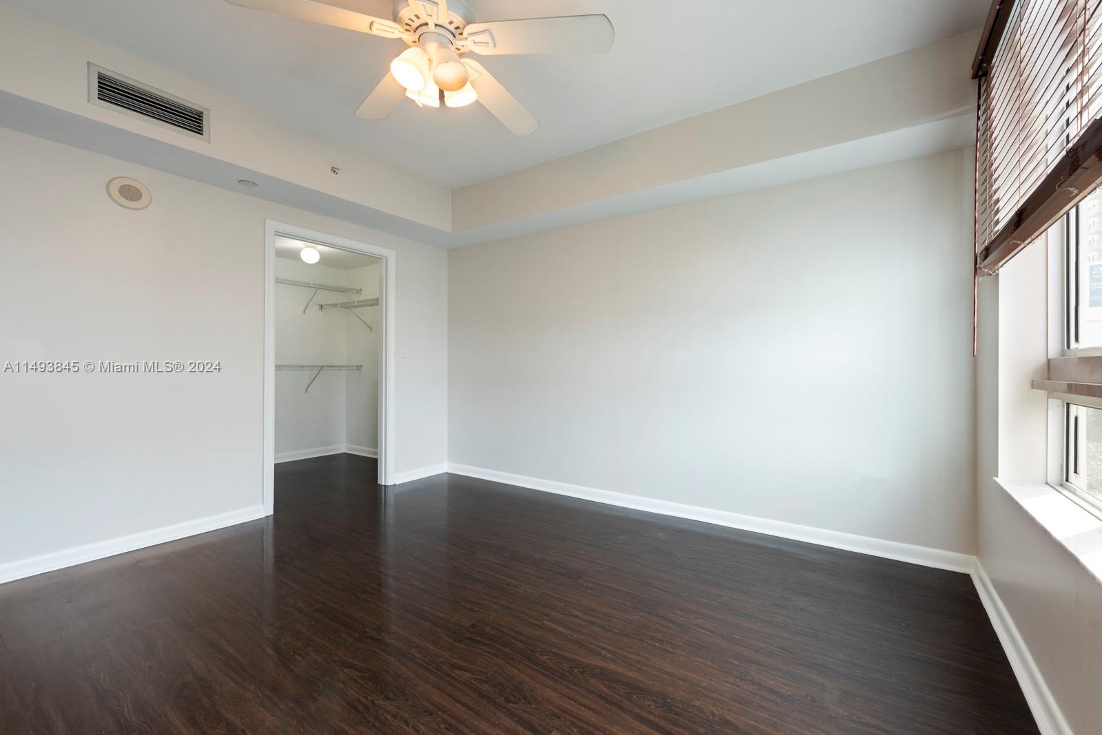 7355 Southwest 89th Street, Unit 510N Miami, FL 33156 - Photo 28 of 52 wooden floor in an empty room with a window