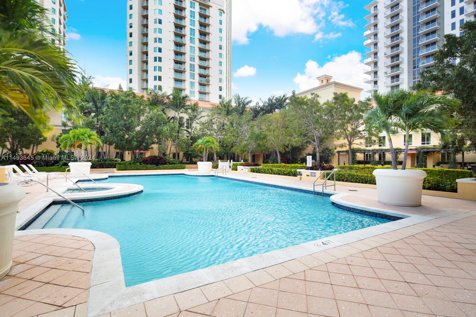 7355 Southwest 89th Street, Unit 510N Miami, FL 33156 - Photo 36 of 52 a view of a swimming pool and lounge chairs