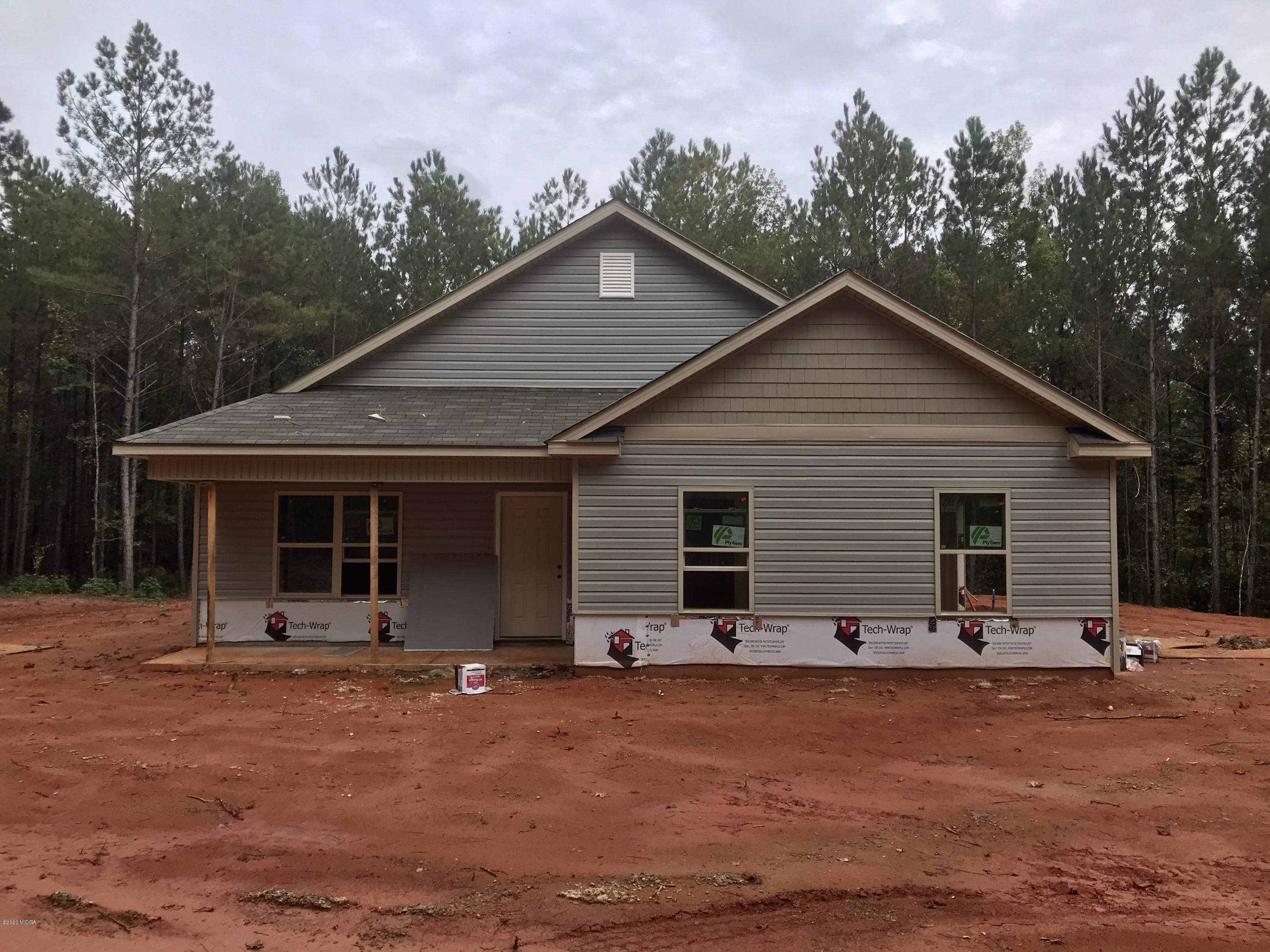 245 Castleberry Road Forsyth, GA 31029 - Photo 1 of 1 a backyard of a house with yard and trees