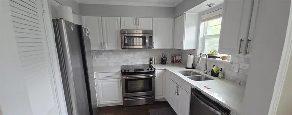 a kitchen with a sink stove and refrigerator