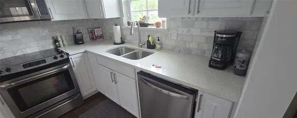 a kitchen with a sink stove and cabinets