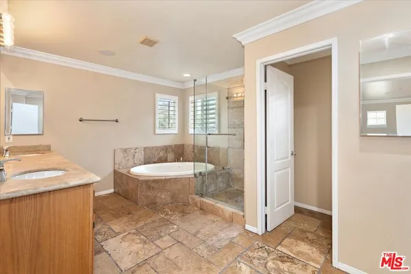 a bathroom with a granite countertop sink a toilet a mirror and bathtub