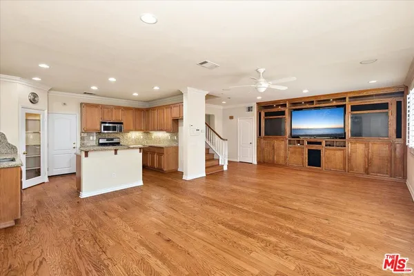 a view of kitchen with furniture and wooden floor