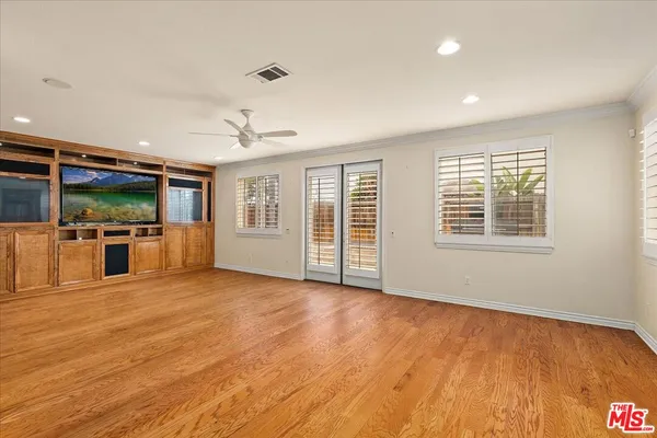 a view of a kitchen with microwave and windows