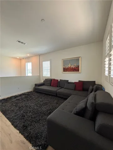 a living room with couches and window