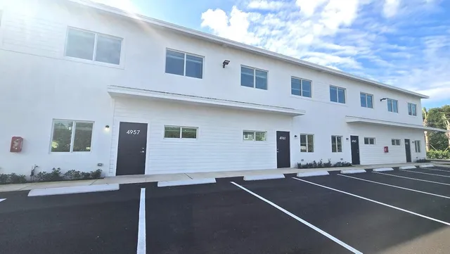 a front view of a house with lots of white walls