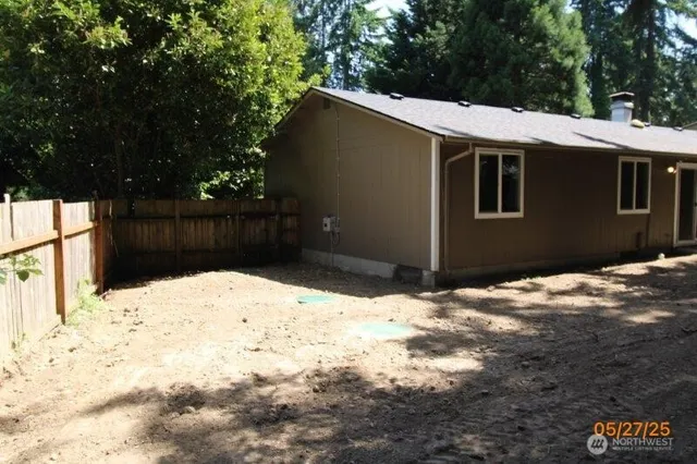 a backyard of a house with large trees