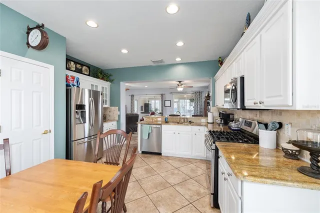 a spacious bathroom with a granite countertop sink a toilet and a shower