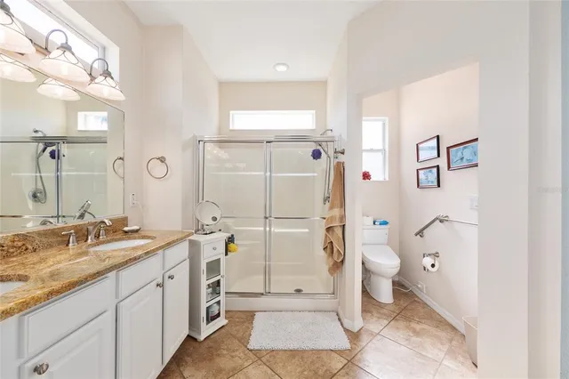 a view of a livingroom with furniture wooden floor and windows