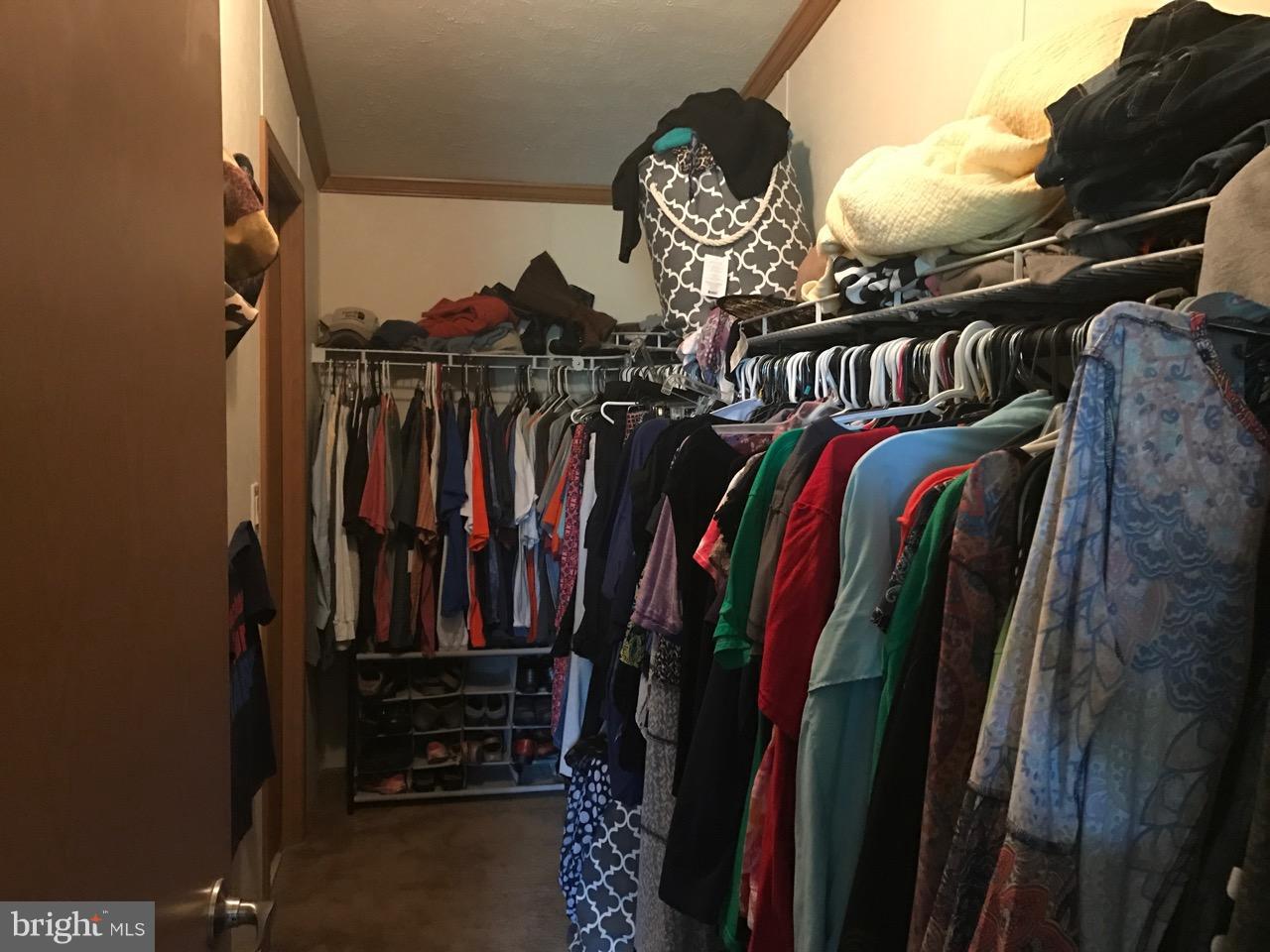 25795 Garey Road Denton, MD 21629 - Photo 15 of 22 a view of walk in closet with clothes and shoes
