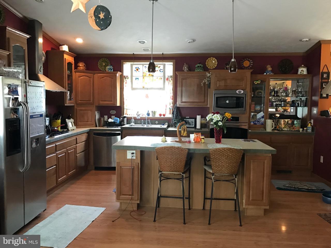 25795 Garey Road Denton, MD 21629 - Photo 6 of 22 a kitchen with stainless steel appliances granite countertop a sink a stove and a refrigerator