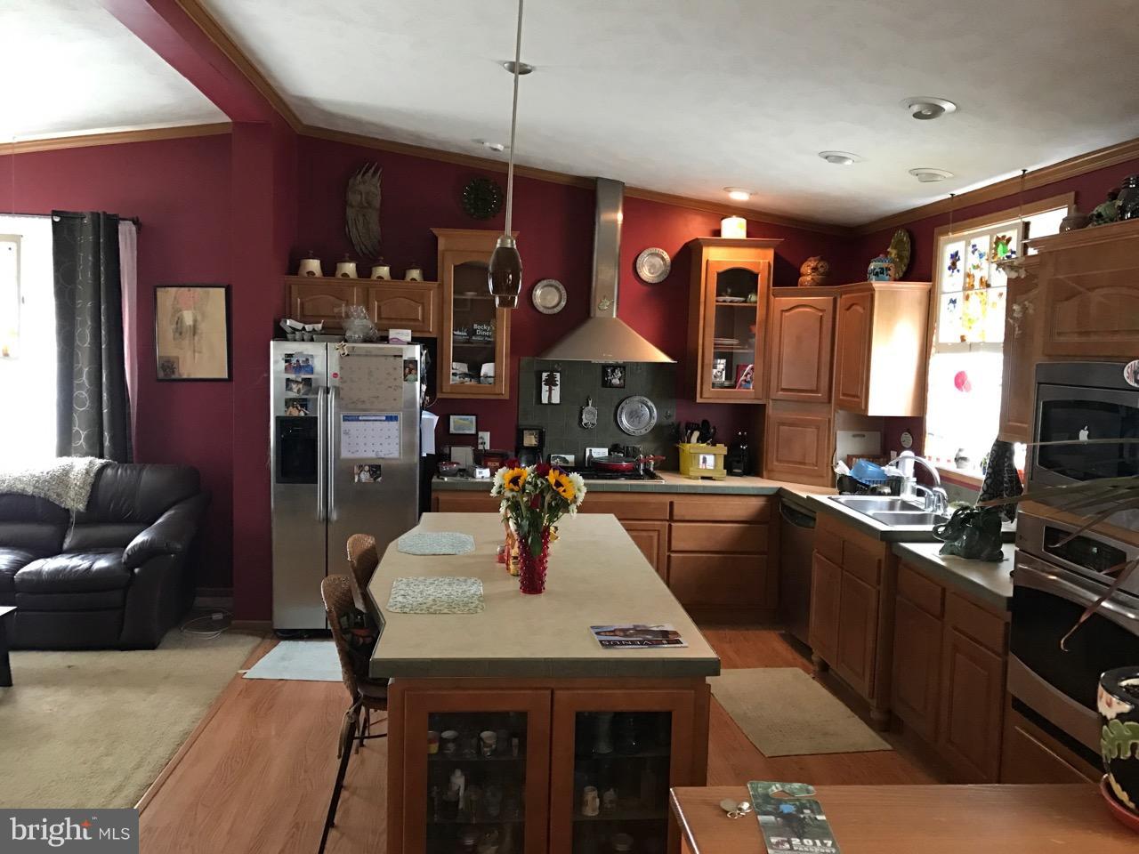 25795 Garey Road Denton, MD 21629 - Photo 7 of 22 a kitchen with stainless steel appliances granite countertop a sink a stove and a refrigerator