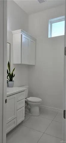 a bathroom with a sink a toilet and vanity