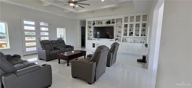 a living room with furniture a flat screen tv and a window