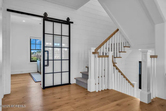 a view of staircase with railing and white walls