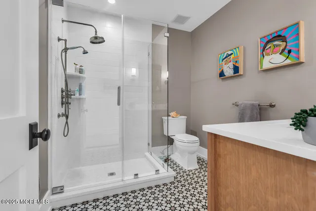 a bathroom with a shower and a sink