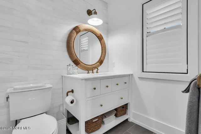 a bathroom with a toilet a sink and a mirror