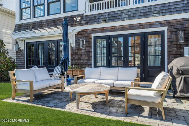 a view of a patio with couches table and chairs and potted plants