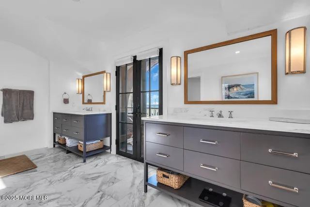 a bathroom with a sink double vanity and a mirror