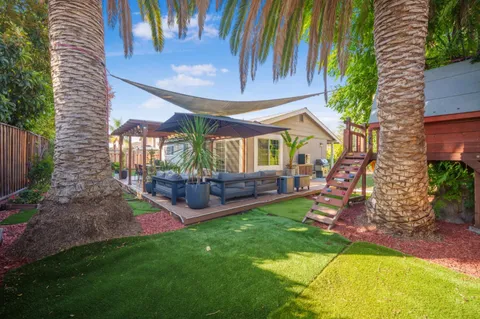 a view of a house with a backyard porch and sitting area