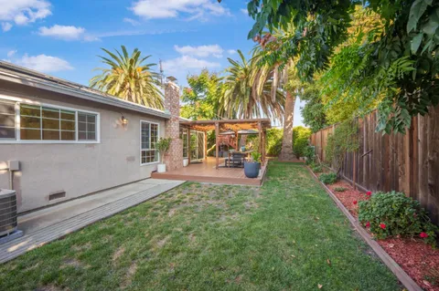 a view of a chair and table in the backyard
